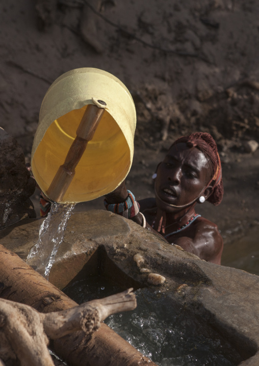 Rendille tribe man taking water in a singing well for his camels, Marsabit district, Ngurunit, Kenya