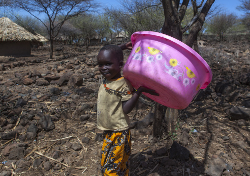 Child carrying a big bucket, Baringo county, Baringo, Kenya