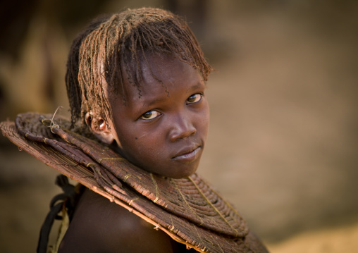A pokot girl wears large necklaces made from the stems of sedge grass, Baringo county, Baringo, Kenya