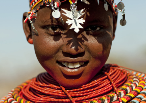 Portrait of a smiling Samburu tribe girl with beaded necklaces, Samburu County, Maralal, Kenya