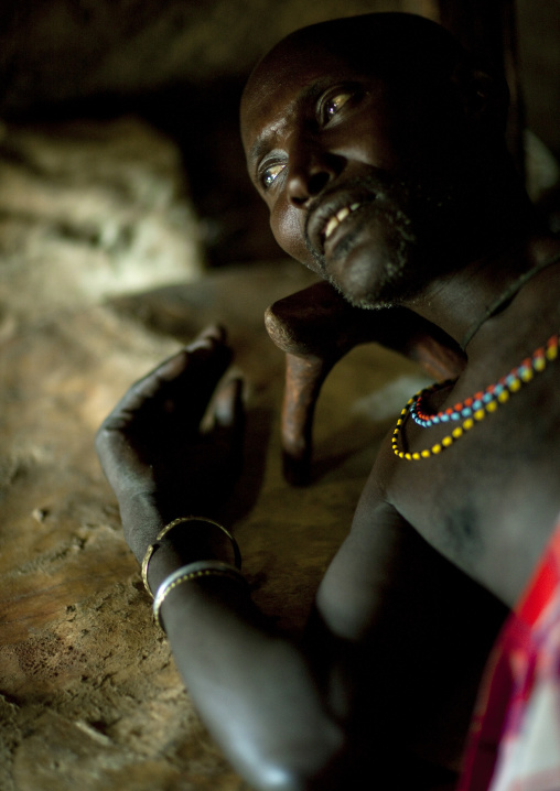 Portrait of a Samburu tribe warrior resting on his bed, Samburu County, Maralal, Kenya