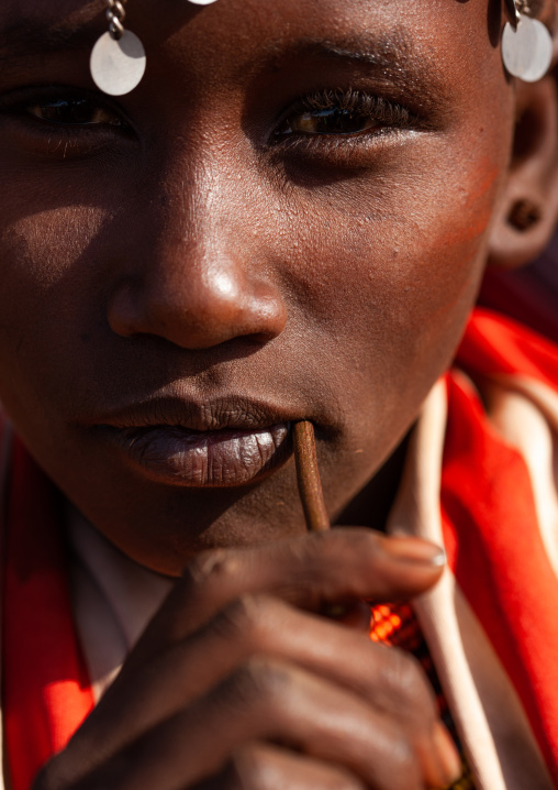 Portait of a young Rendille tribe woman with a wooden stick in the mouth, Marsabit County, Marsabit, Kenya