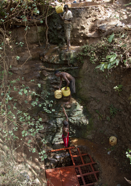 Men collecting water in a Borana singing well, Marsabit County, Marsabit, Kenya