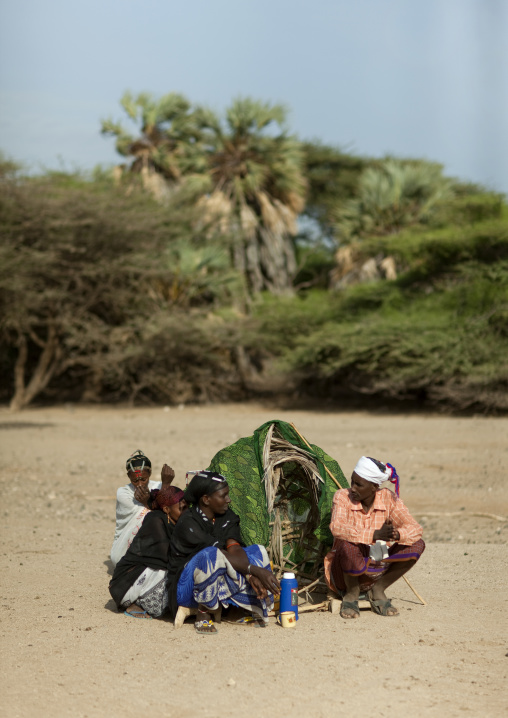 Gabra tribe people sitting around a small shelter in the desert, Marsabit County, Chalbi Desert, Kenya