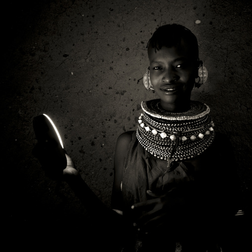 Portrait of a Turkana tribe woman holding a flash, Rift Valley Province, Turkana lake, Kenya