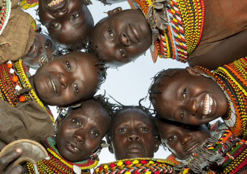Turkana tribeswomen in circle looking down, Turkana lake, Loiyangalani, Kenya