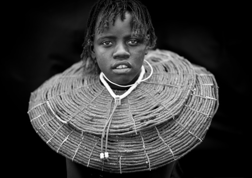 A pokot girl wears large necklaces made from the stems of sedge grass, Baringo county, Baringo, Kenya