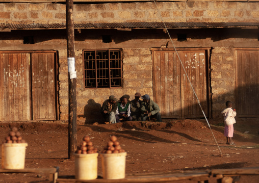 Kenyan men chatting in front of a building, Nakuru County, Nakuru, Kenya