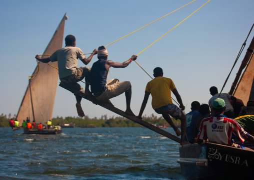 Man balancing dhow while sailing, Lamu County, Lamu, Kenya