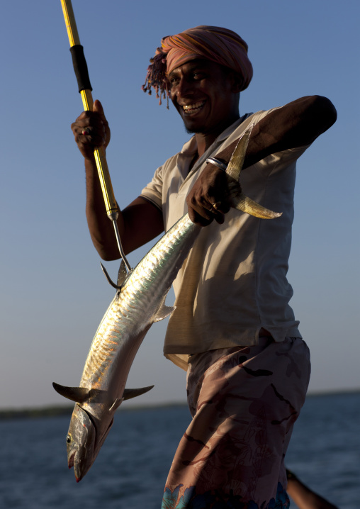 Fisherman holding a big fish, Lamu County, Lamu, Kenya