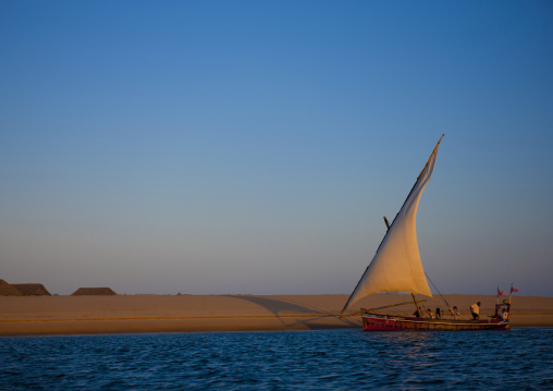 Dhow boat sailing at dusk along kizingoni coast, Lamu County, Lamu, Kenya