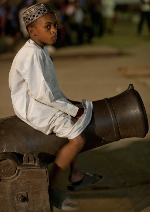 Muslim boy sit on a cannon, Lamu County, Lamu, Kenya