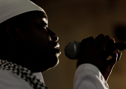 Muslim man speaking microphone during Maulid festival, Lamu County, Lamu, Kenya