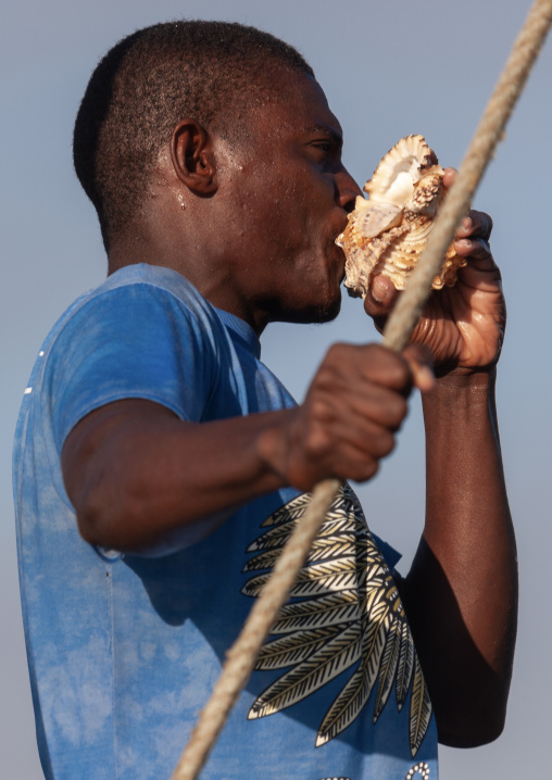 Sailor blowing in a shell, Lamu County, Lamu, Kenya