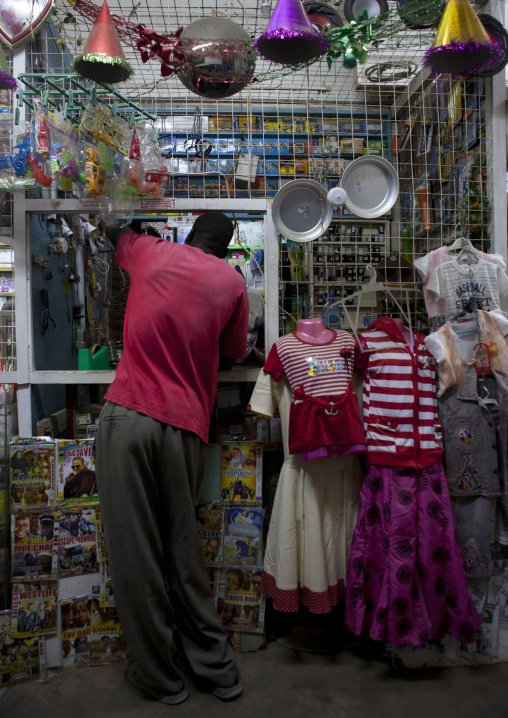 Man buying goods at a shop counter, Lamu County, Lamu, Kenya