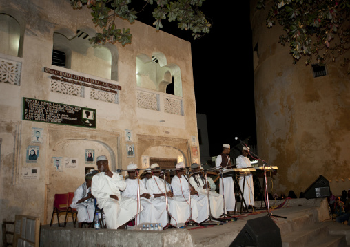 Muslim men reciting poetry at night time during Maulid festival, Lamu County, Lamu, Kenya