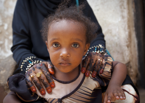 Muslim woman with henna painted hands and her daughter, Lamu County, Lamu, Kenya