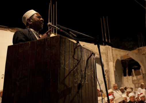 A muslim man speaking in a microphone during Maulid festival, Lamu County, Lamu, Kenya