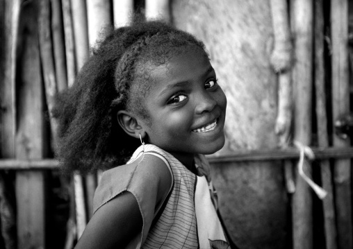Young smiling girl with braids looking at camera, Lamu County, Lamu, Kenya