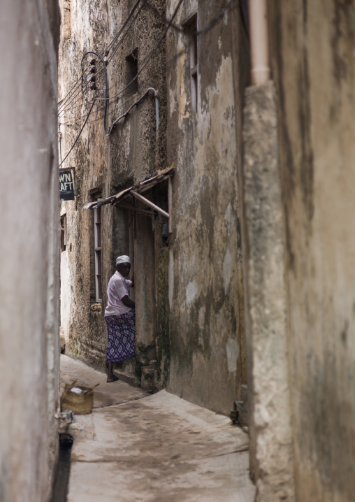 Mulsim man entering his house in a narrow street, Lamu County, Lamu, Kenya