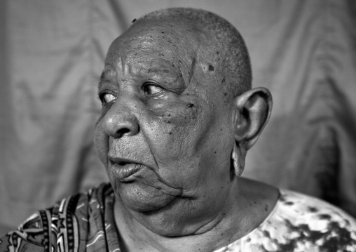 Portrait of a senior woman with shaved head and enlarged earlobes, Lamu County, Siyu, Kenya