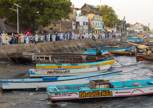 Sunni muslim people parading during the maulidi festivities along the harbour, Lamu county, Lamu town, Kenya