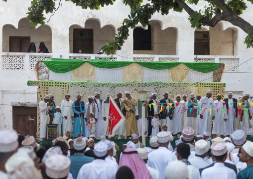Sunni muslim men during the maulidi festivities on the main square, Lamu county, Lamu town, Kenya