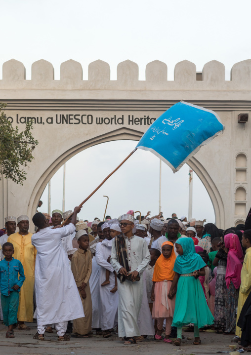 Sunni muslim people parading in front of the town gate during the maulidi festivities in the street, Lamu county, Lamu town, Kenya