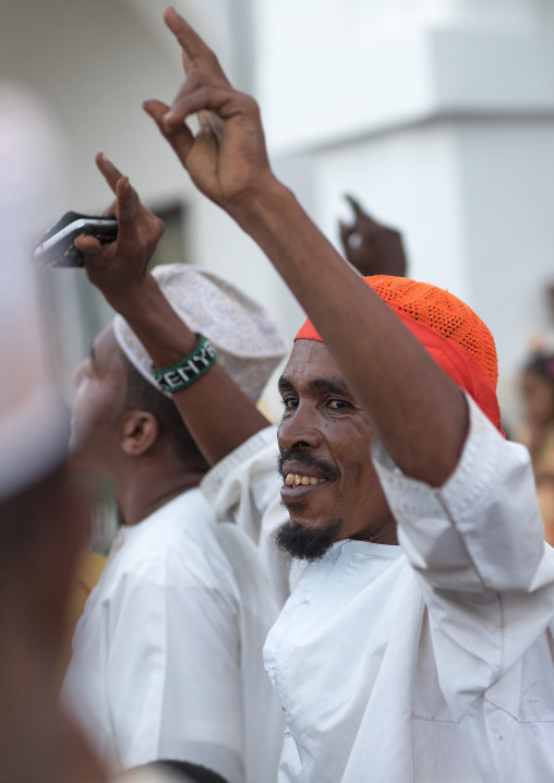 Sunni muslim men celebrating the maulidi festivities in the street, Lamu county, Lamu town, Kenya