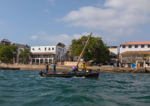 A dhow passng in front of the old town, Lamu county, Lamu town, Kenya