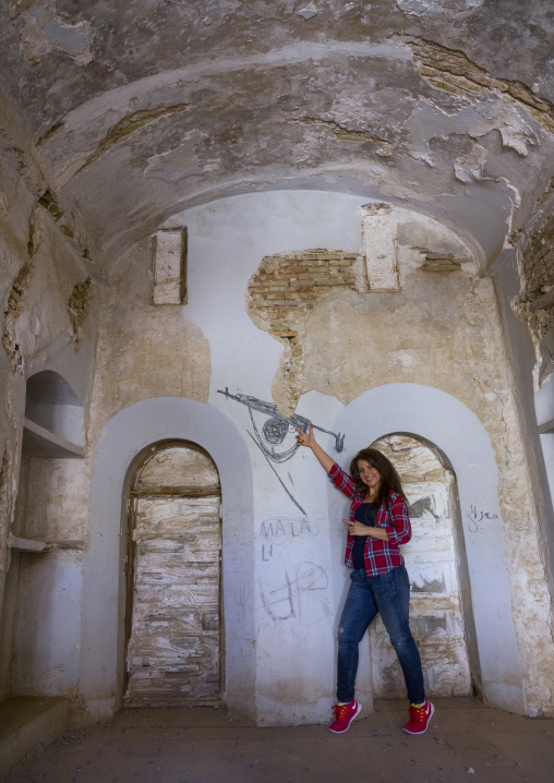 Woman Inside An Old House In The Erbil Citadel Playing With A Drawn Kalashnikov, Kurdistan, Iraq