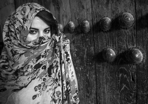 Woman With Beautiful Eyes Hidding Behind A Veil In Front Of An Old Wooden Door, Koya, Kurdistan, Iraq