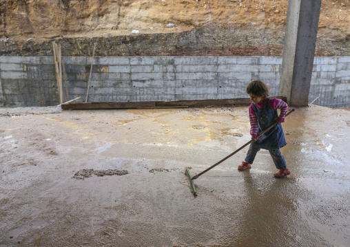 Yezidi Refugee Displaced From Sinjar Living In An Under Construction Building And Cleaning After A Storm, Duhok, Kurdistan, Iraq