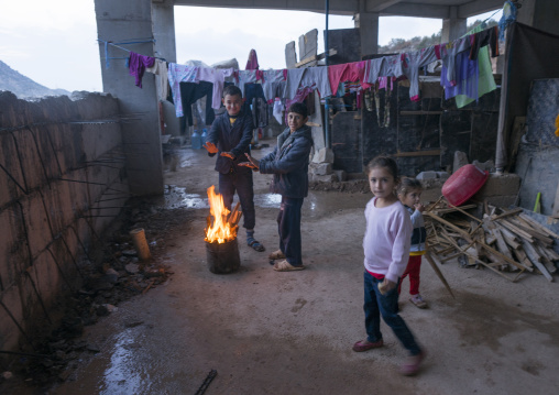 Yazidi Refugees Children Displaced From Sinjar Making Fire In An Under Construction Building, Duhok, Kurdistan, Iraq