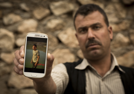 Yezedi Refugee From Sinjar Showing The Picture Of His Dead Relative Killed By Daesh On His Mobile Phone, Lalesh Temple, Kurdistan, Iraq