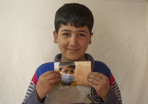 Elias, A Syrian Refugee In Qushtapa Refugee Camp Holding A Picture Of Himselgf When He Was Ill, Erbil, Kurdistan, Iraq