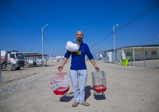 Man Carrying Bird Cages In Qushtapa Refugee Camp, Erbil, Kurdistan, Iraq