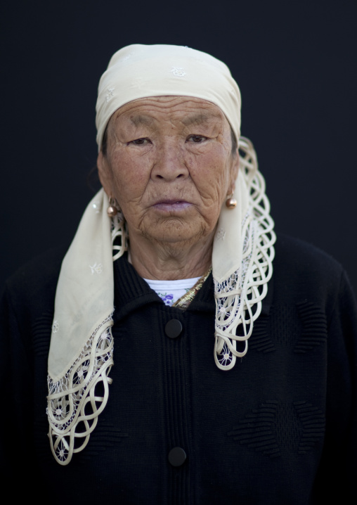 Old Woman Wearing A Headscarf At The Animal Market Of Kochkor, Kyrgyzstan