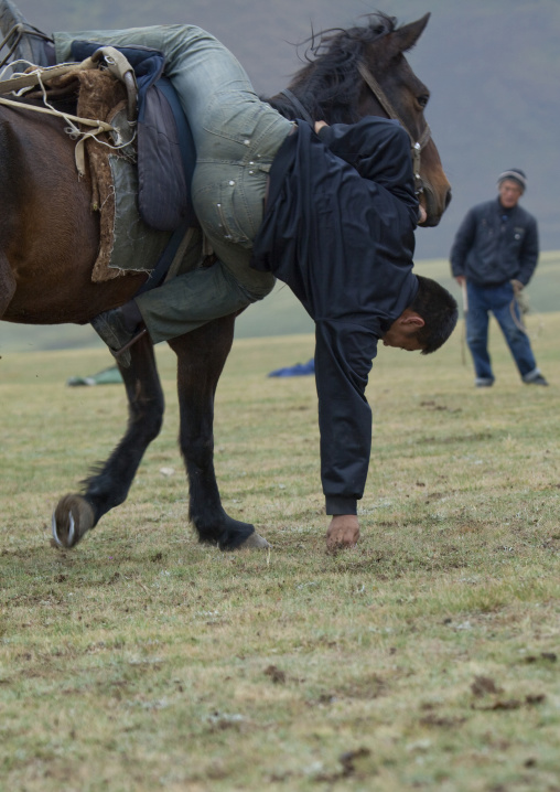 Horseman Picking Up Something On The Ground While Riding A Horse, During Horse Game, Saralasaz Jailoo Area, Kyrgyzstan