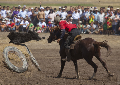 Horseman Throwing A Headless Goat Carcass During The Horse Game On National Day, Bishkek, Kyrgyzstan