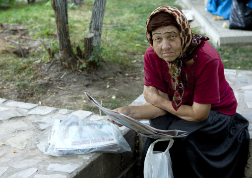 Old Veiled Woman Reading A Newspaper, Bishkek, Kyrgyzstan