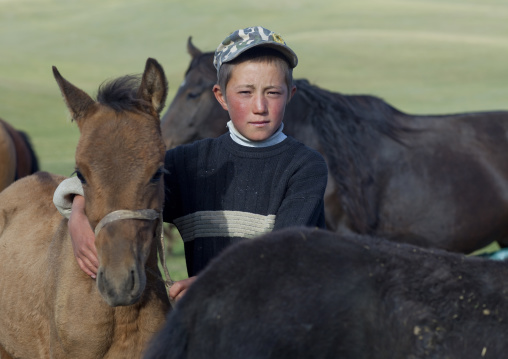 Boy In The Middle Of Colts, Jaman Echki Jailoo Village, Song Kol Lake Area, Kyrgyzstan