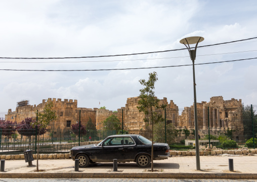 Car parked in front of the antique ruins at the archeological site, Beqaa Governorate, Baalbek, Lebanon