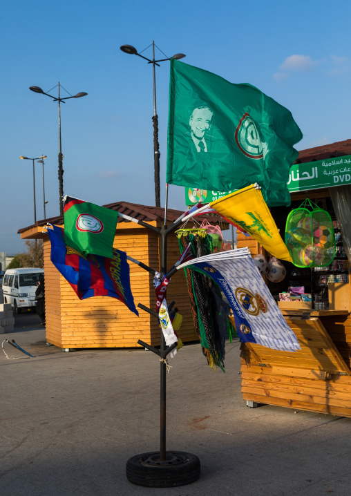 Flags with Hezbollah logo for sale with Barcelona and Madrid ones as tourist souvenirs, South Governorate, Tyre, Lebanon