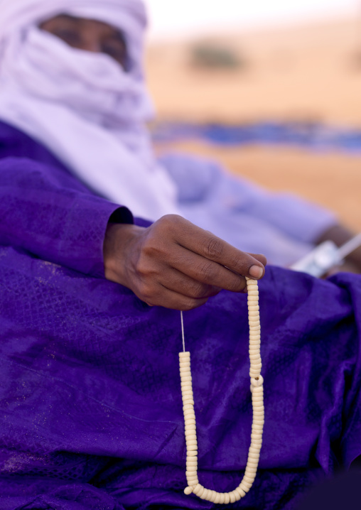 Tuareg man praying with beads, Fezzan, Umm al-Maa, Libya