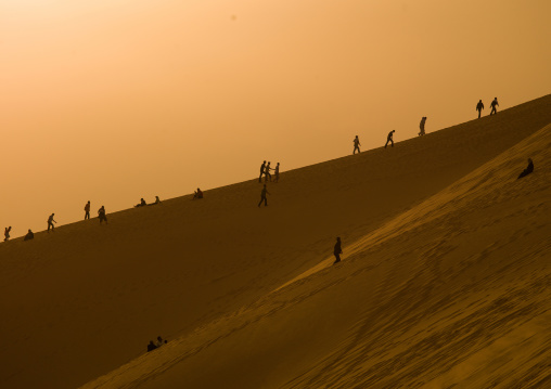 People in the desert on a dune, Tripolitania, Ghadames, Libya