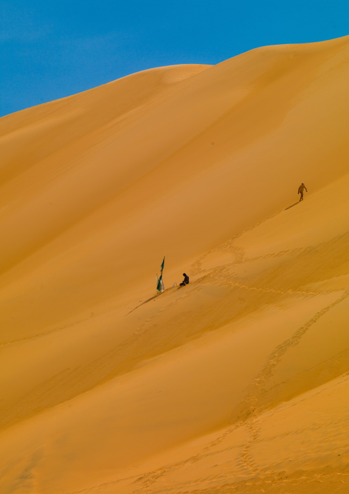 People climbing the dunes in ubari desert, Fezzan, Umm al-Maa, Libya