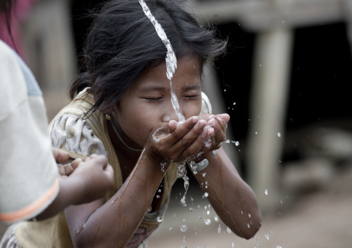 Khmu minority girl drinking water, Xieng khouang, Laos