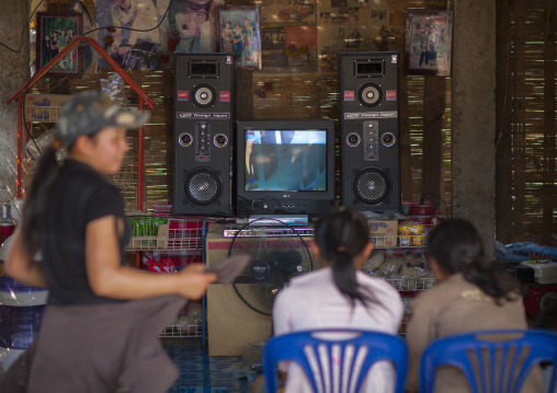 Lao lum teenagers watching television, Pakbeng, Laos