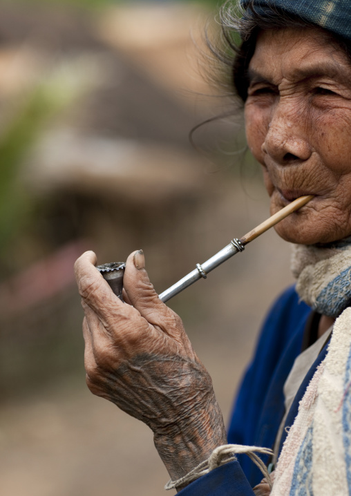 Khmu minority woman smoking pipe, Xieng khouang, Laos